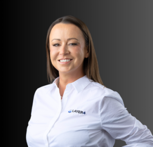 Smiling woman in a white shirt with Layer 4 logo, representing the senior team of the managed IT services provider.