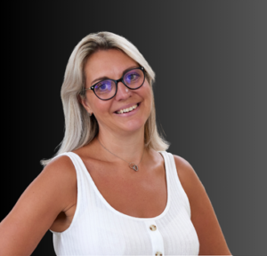 Smiling woman with blonde hair and glasses, wearing a white top, representing the senior team at Layer 4, a managed IT services provider.