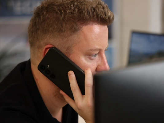 Business professional using mobile phone for work
