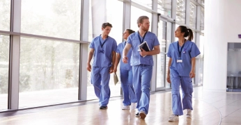 Healthcare professionals walking through a hospital corridor