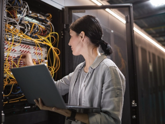 IT technician reviewing servers preparing for cloud migration